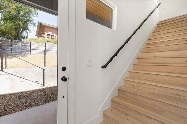 a view of entryway and hall with wooden floor