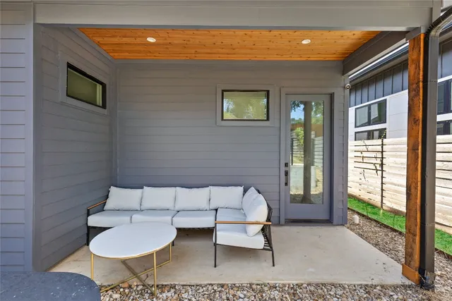 a balcony with table and chairs