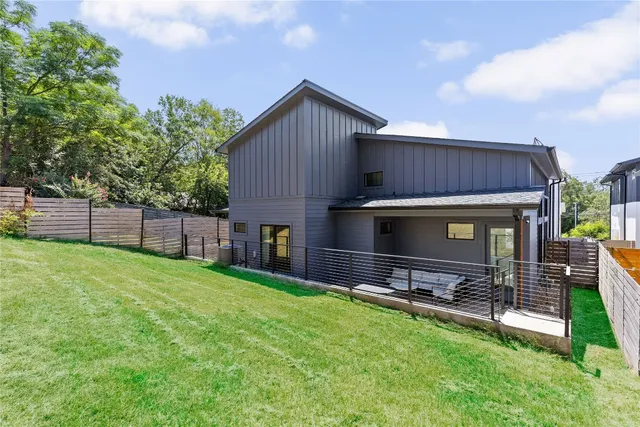 a view of a backyard with a garden and entertaining space