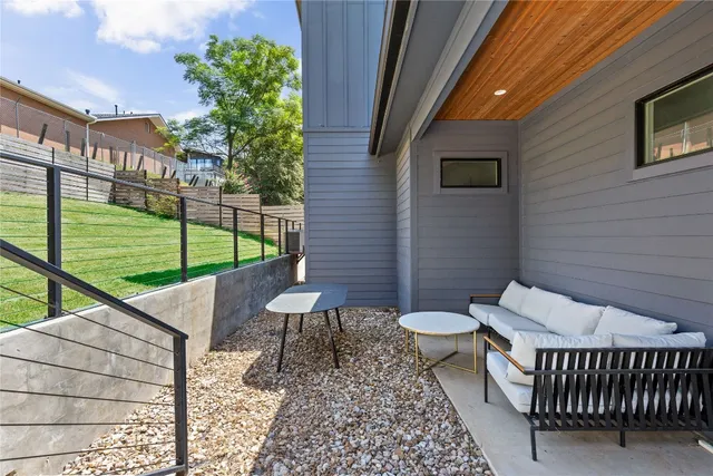 a view of a patio with a table and chairs