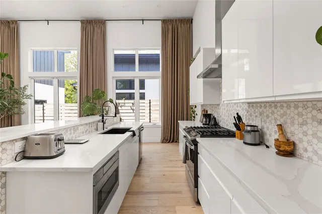 a kitchen with a sink stove and cabinets