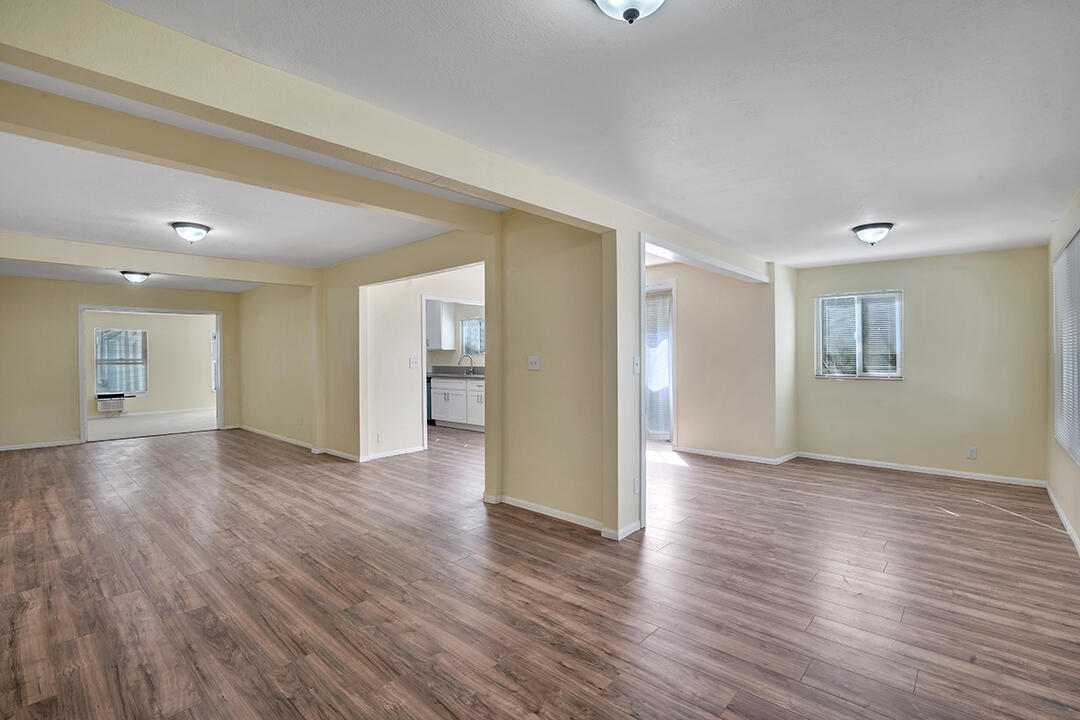 3050 Lime Street Riverside, CA 92501 - Photo 3 of 35 a view of an empty room with wooden floor and a window