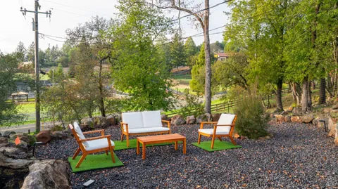a backyard of a house with table and chairs