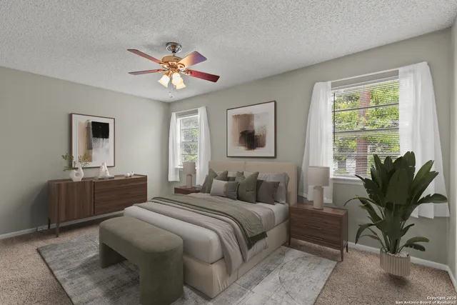 a bedroom with a large bed and a chandelier