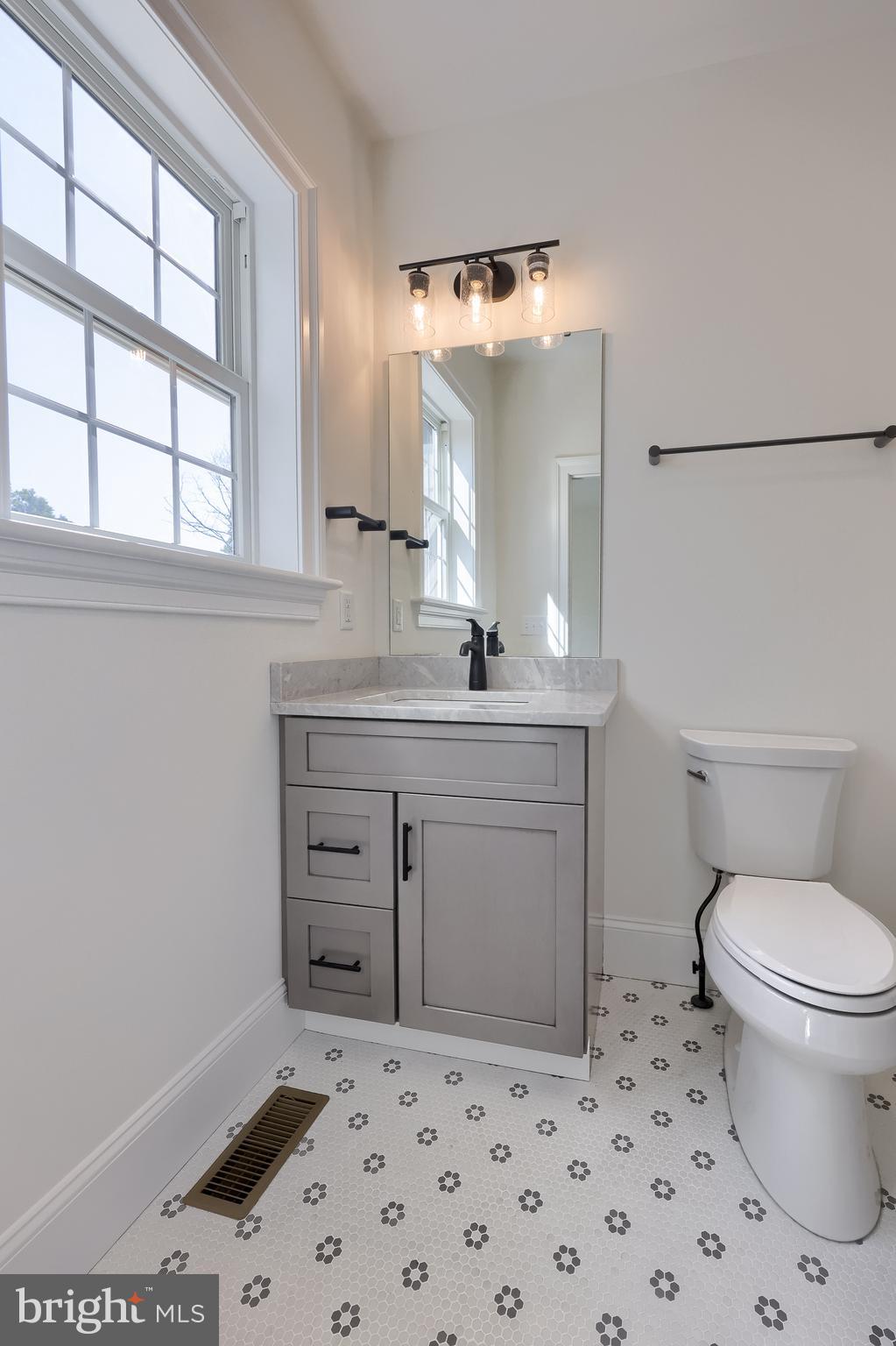 421 Southampton Drive Lititz, PA 17543 - Photo 39 of 49 a bathroom with a sink a toilet a mirror and a window