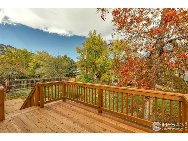 a view of balcony with wooden floor and fence