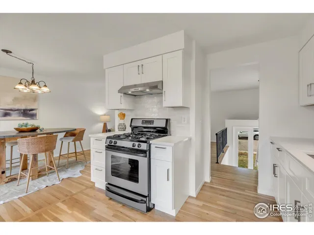 a kitchen with stainless steel appliances a white stove top oven and a refrigerator