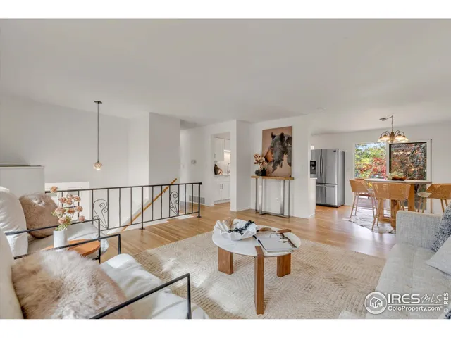 a living room with furniture a rug and white walls