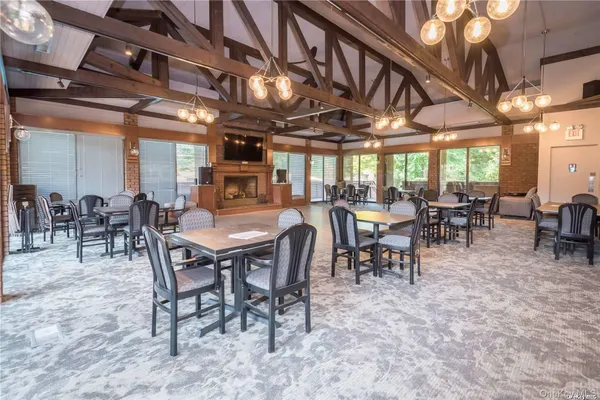 a dining room with furniture a chandelier and a rug