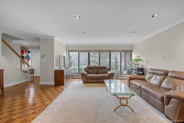 a living room with furniture a dining table and a rug
