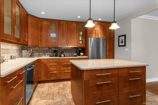 a kitchen with stainless steel appliances granite countertop a table chairs sink and cabinets