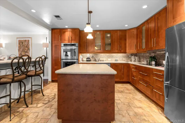 a kitchen that has a sink a table and chairs in it