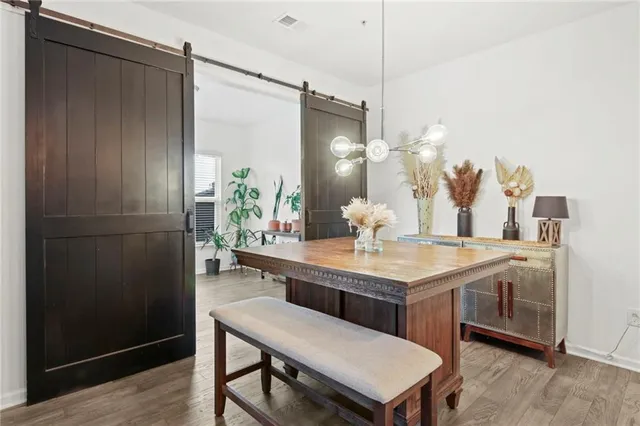 a dining room with a table chairs and entryway