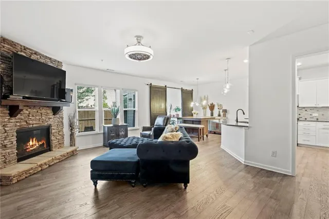 a kitchen with stainless steel appliances granite countertop a sink refrigerator and cabinets