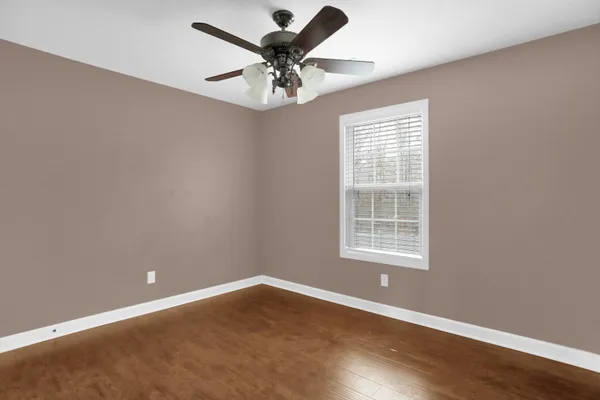 a view of kitchen with microwave a stove and cabinets
