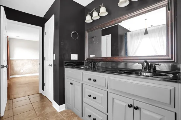 a bath room with a sink and a window