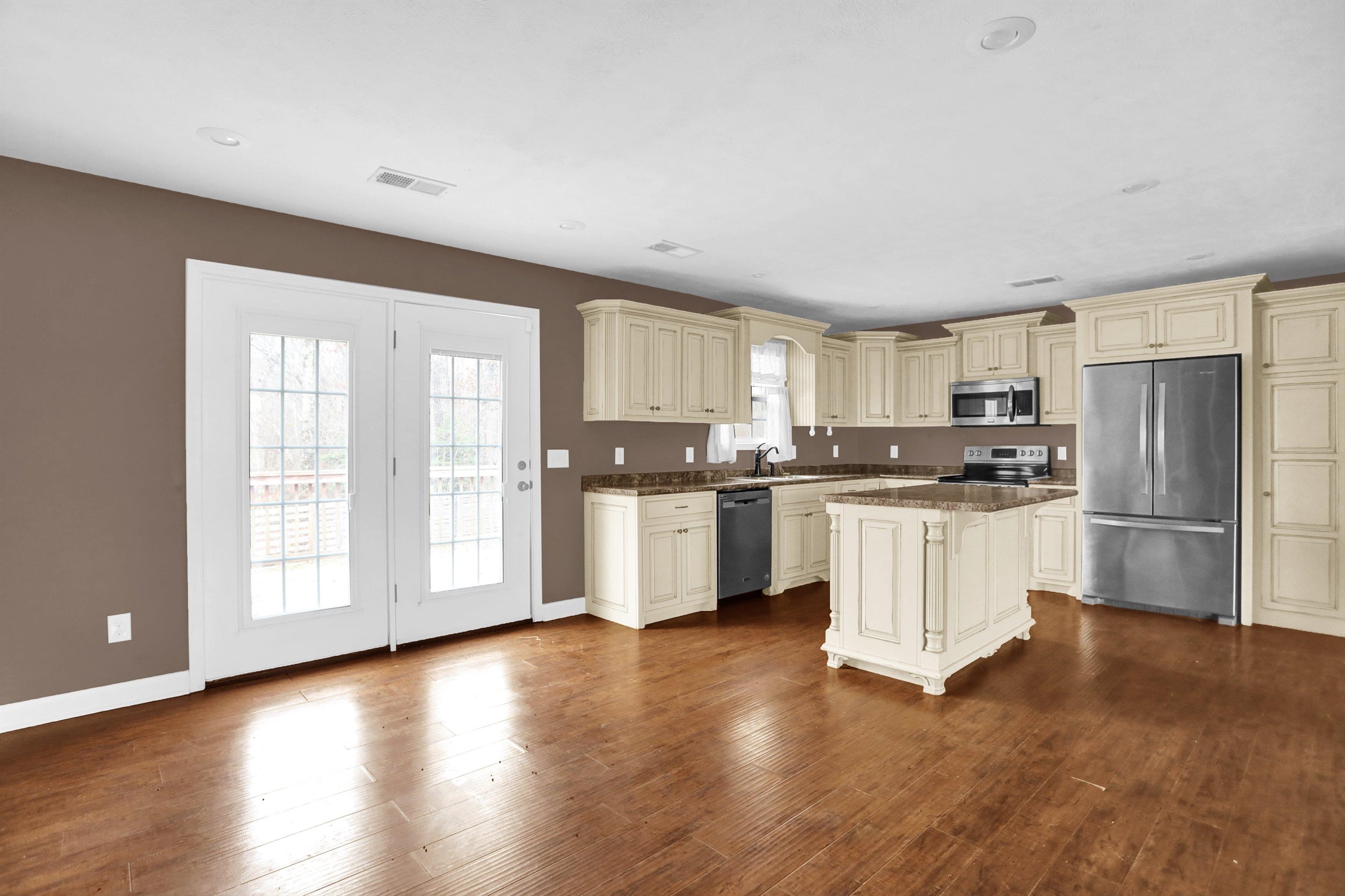 186 King Road Selmer, TN 38375 - Photo 9 of 30 a kitchen with granite countertop white cabinets and stainless steel appliances