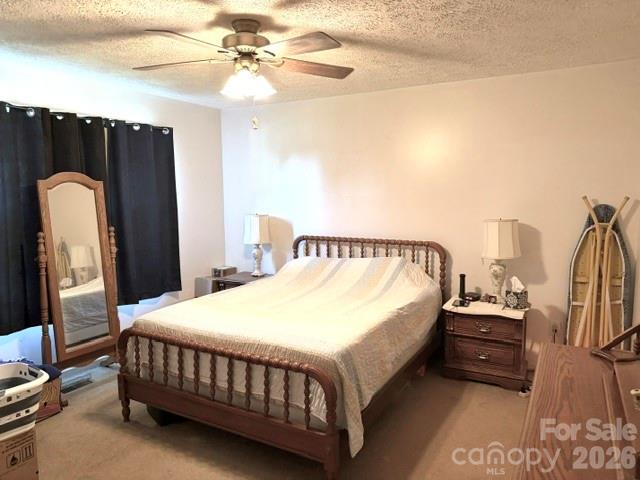 4084 Carpenters Cove Road Claremont, NC 28610 - Photo 11 of 27 a bedroom with a bed and a chandelier