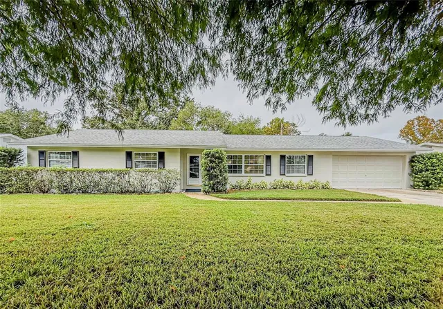 a front view of a house with a garden and patio