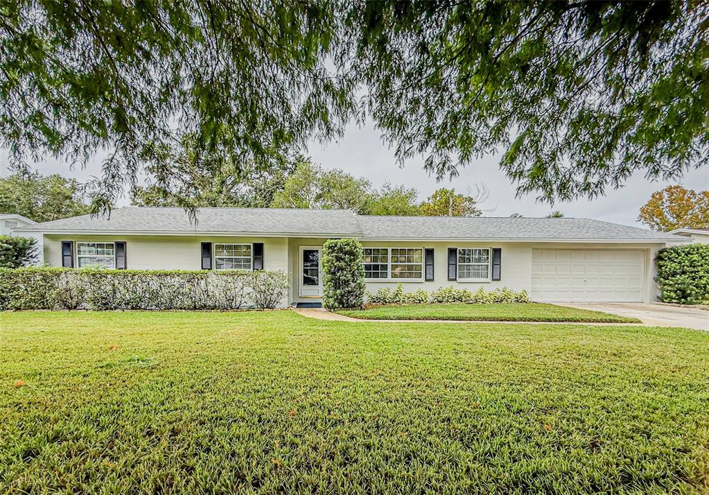 a front view of a house with a garden and patio