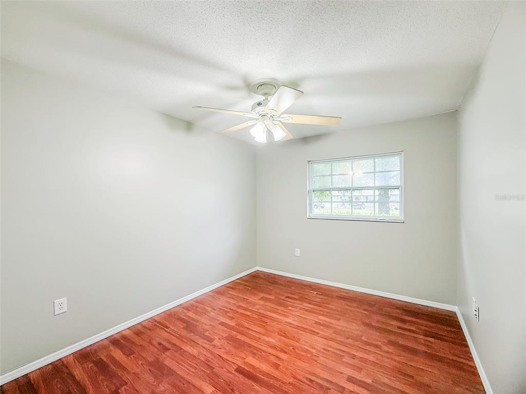 6428 Tula Lane Lakeland, FL 33809 - Photo 11 of 29 wooden floor in an empty room with a window