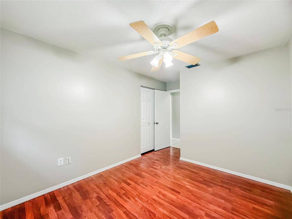 6428 Tula Lane Lakeland, FL 33809 - Photo 12 of 29 an empty room with wooden floor fan and windows
