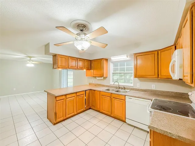 a kitchen with a sink cabinets and window