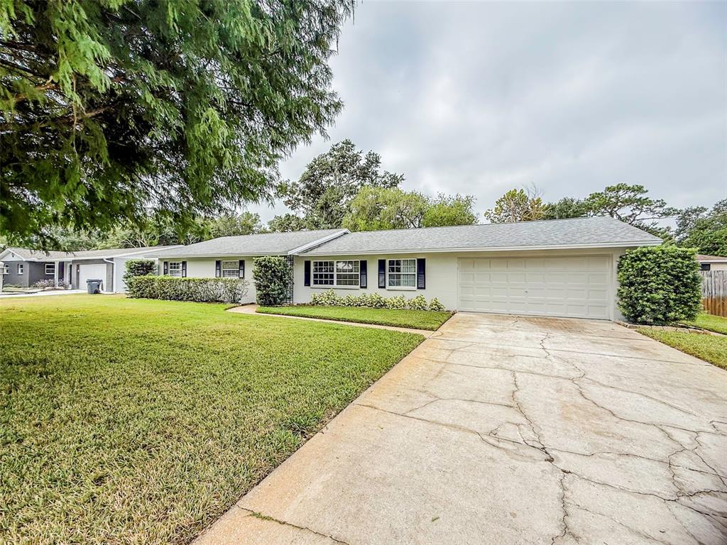 6428 Tula Lane Lakeland, FL 33809 - Photo 2 of 29 a front view of a house with a garden