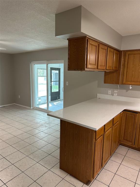 6428 Tula Lane Lakeland, FL 33809 - Photo 26 of 29 a kitchen with a cabinets and chandelier