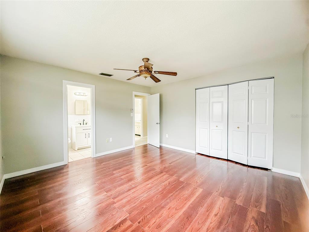 6428 Tula Lane Lakeland, FL 33809 - Photo 6 of 29 a view of a livingroom with wooden floor and a ceiling fan