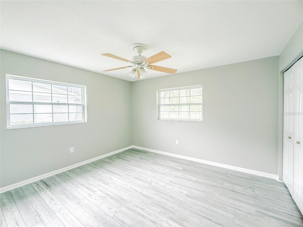 6428 Tula Lane Lakeland, FL 33809 - Photo 8 of 29 wooden floor in an empty room with a window