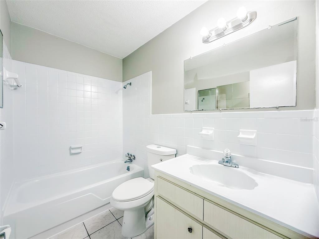 6428 Tula Lane Lakeland, FL 33809 - Photo 10 of 29 a bathroom with a sink a toilet and shower