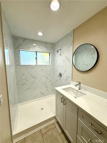 a bathroom with a double vanity sink and a mirror