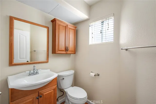 a bathroom with a sink a toilet and mirror
