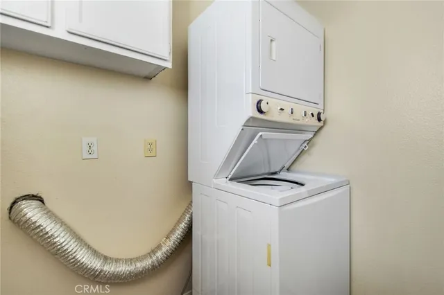 a view of a hallway with washer and dryer