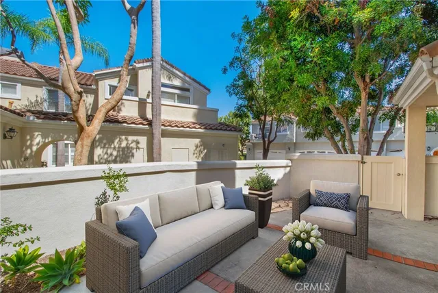 a view of a patio with couches and potted plants