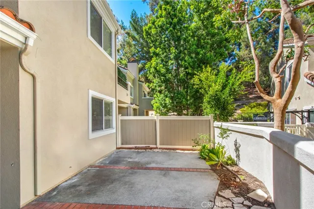 a view of a patio with table and chairs and potted plants