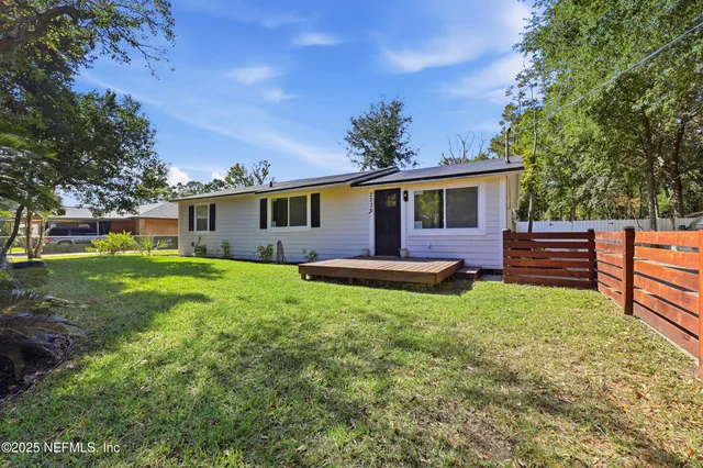 a kitchen with stainless steel appliances granite countertop a sink a stove a refrigerator cabinets and chairs
