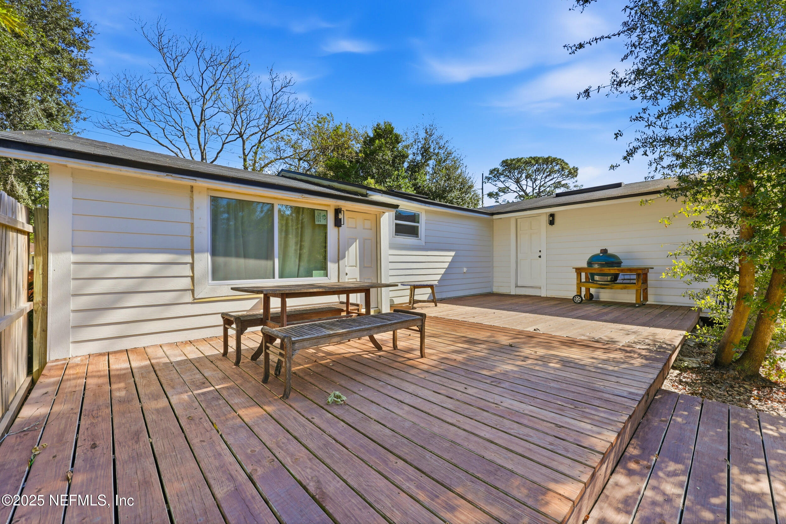2236 Anniston Road Jacksonville, FL 32246 - Photo 18 of 27 a view of a roof deck with table and chairs with wooden floor and fence