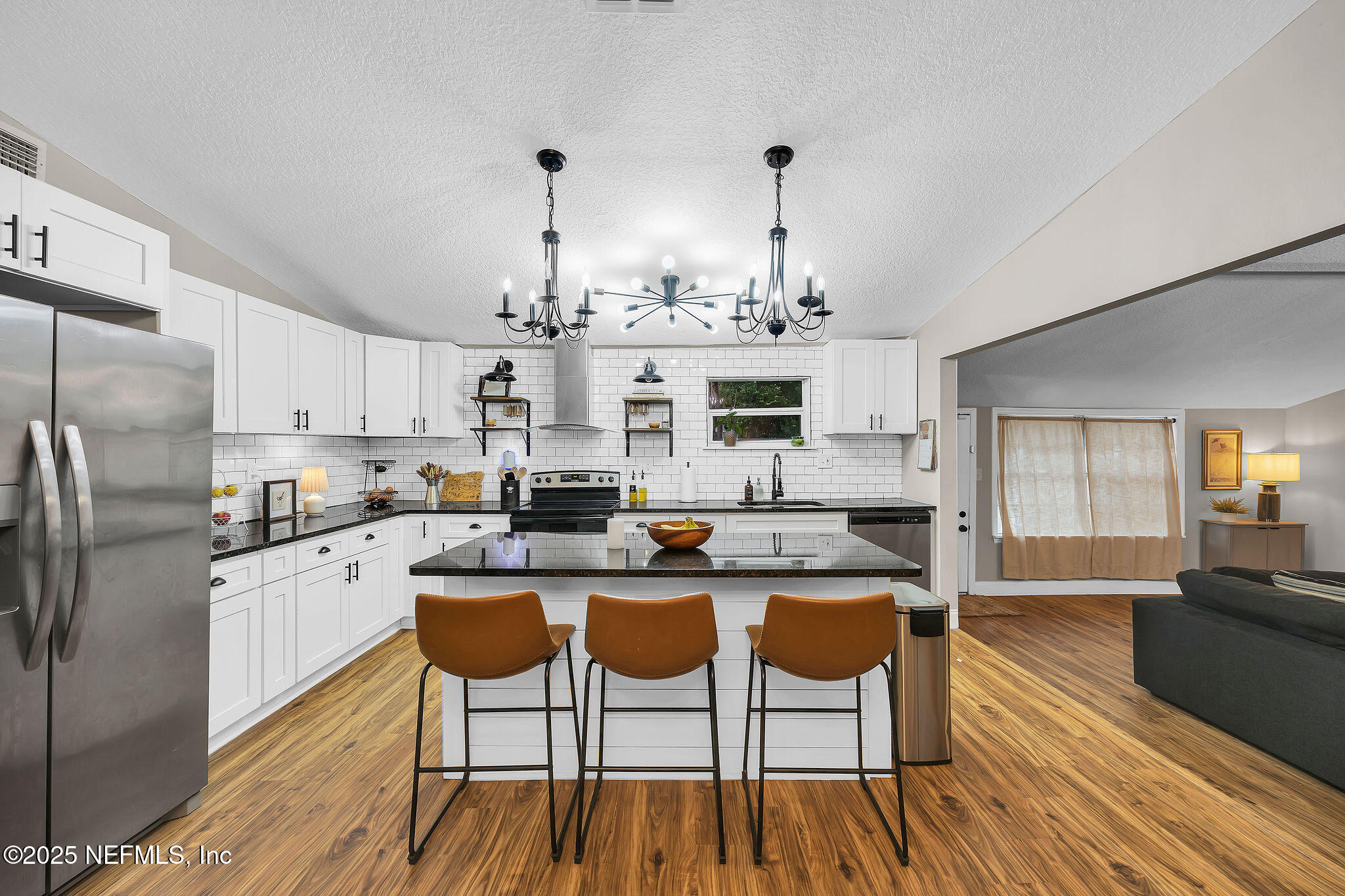 2236 Anniston Road Jacksonville, FL 32246 - Photo 9 of 27 a kitchen with stainless steel appliances kitchen island granite countertop a dining table chairs and granite counter tops