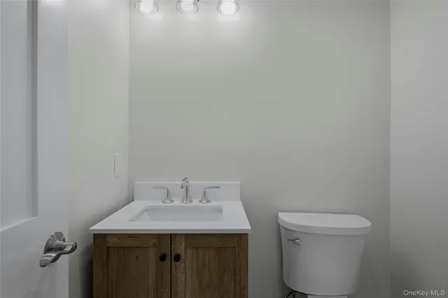 a view of an empty room with a window and fireplace