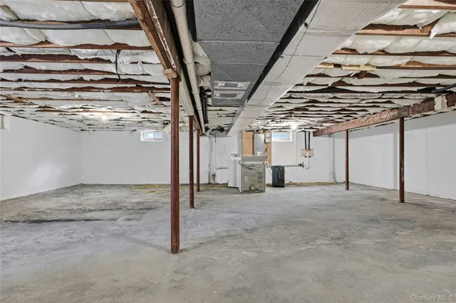 a bathroom with a granite countertop toilet a sink and a window