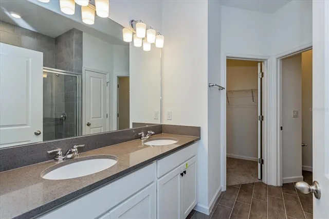 a bathroom with a glass shower door