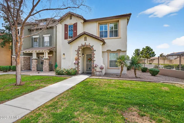 a front view of a house with a garden and plants