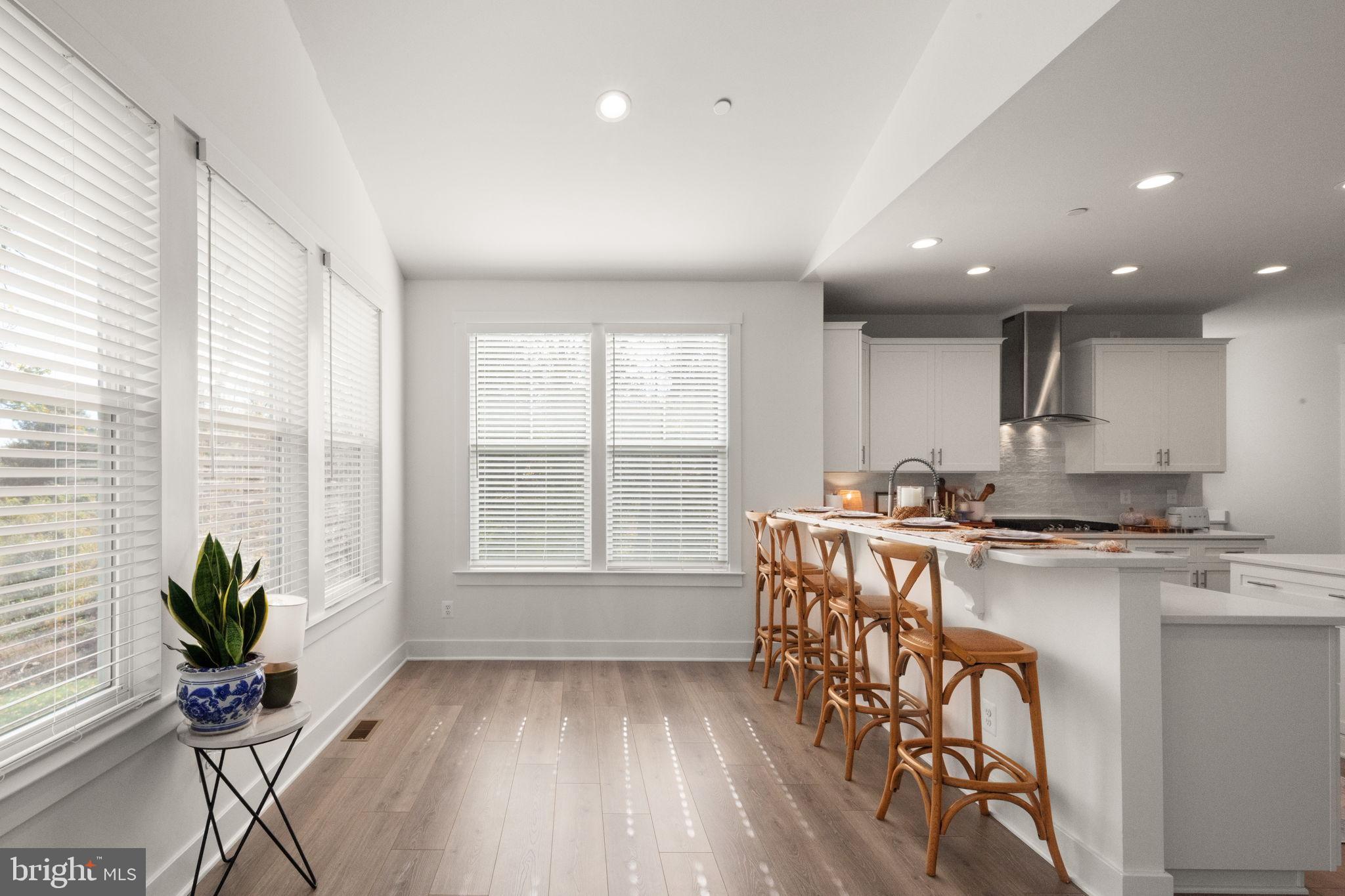 424 Osage Road Cockeysville, MD 21030 - Photo 17 of 52 a kitchen with stainless steel appliances granite countertop sink stove and white cabinets with wooden floor