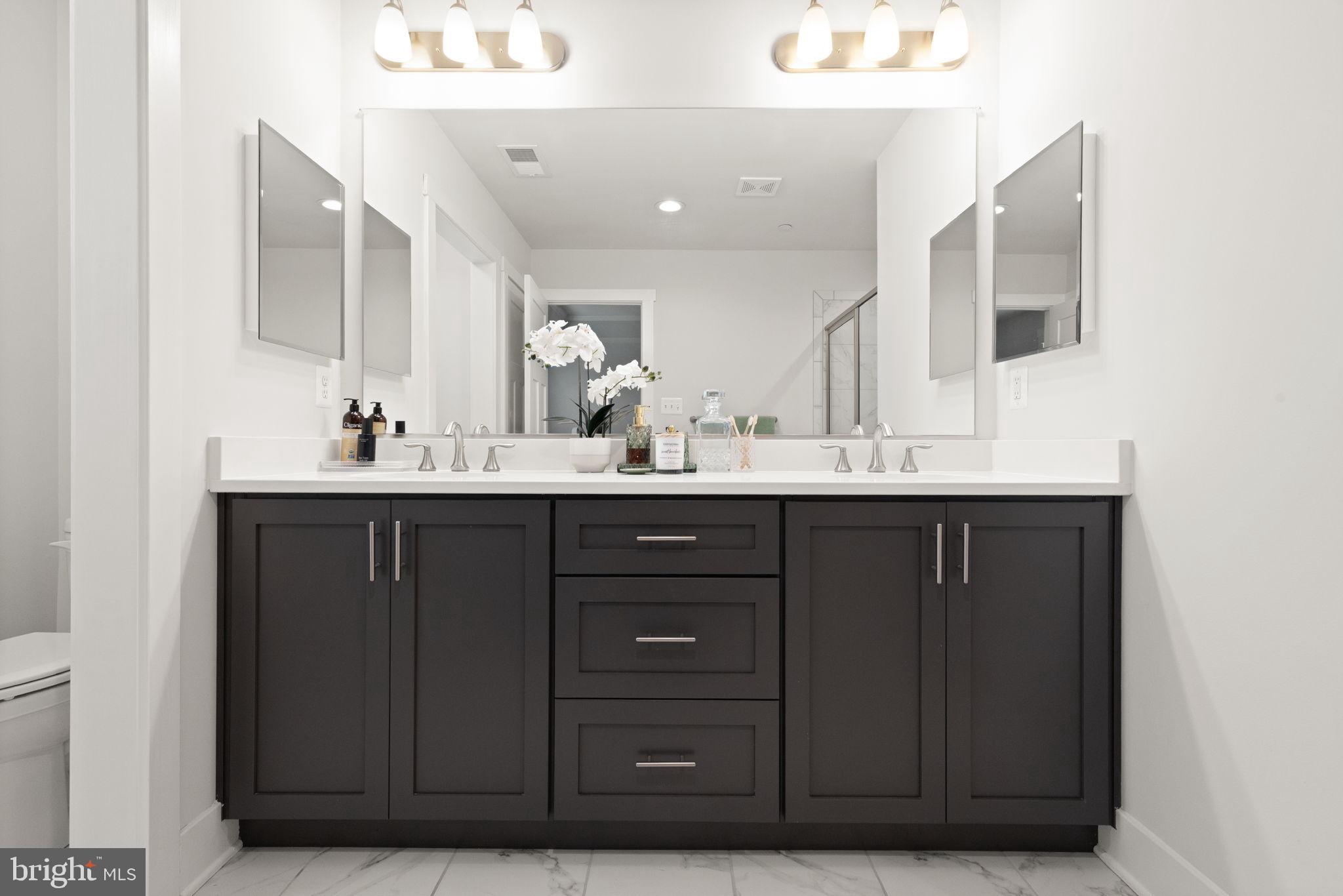 424 Osage Road Cockeysville, MD 21030 - Photo 28 of 52 a bathroom with a double vanity sink and a mirror