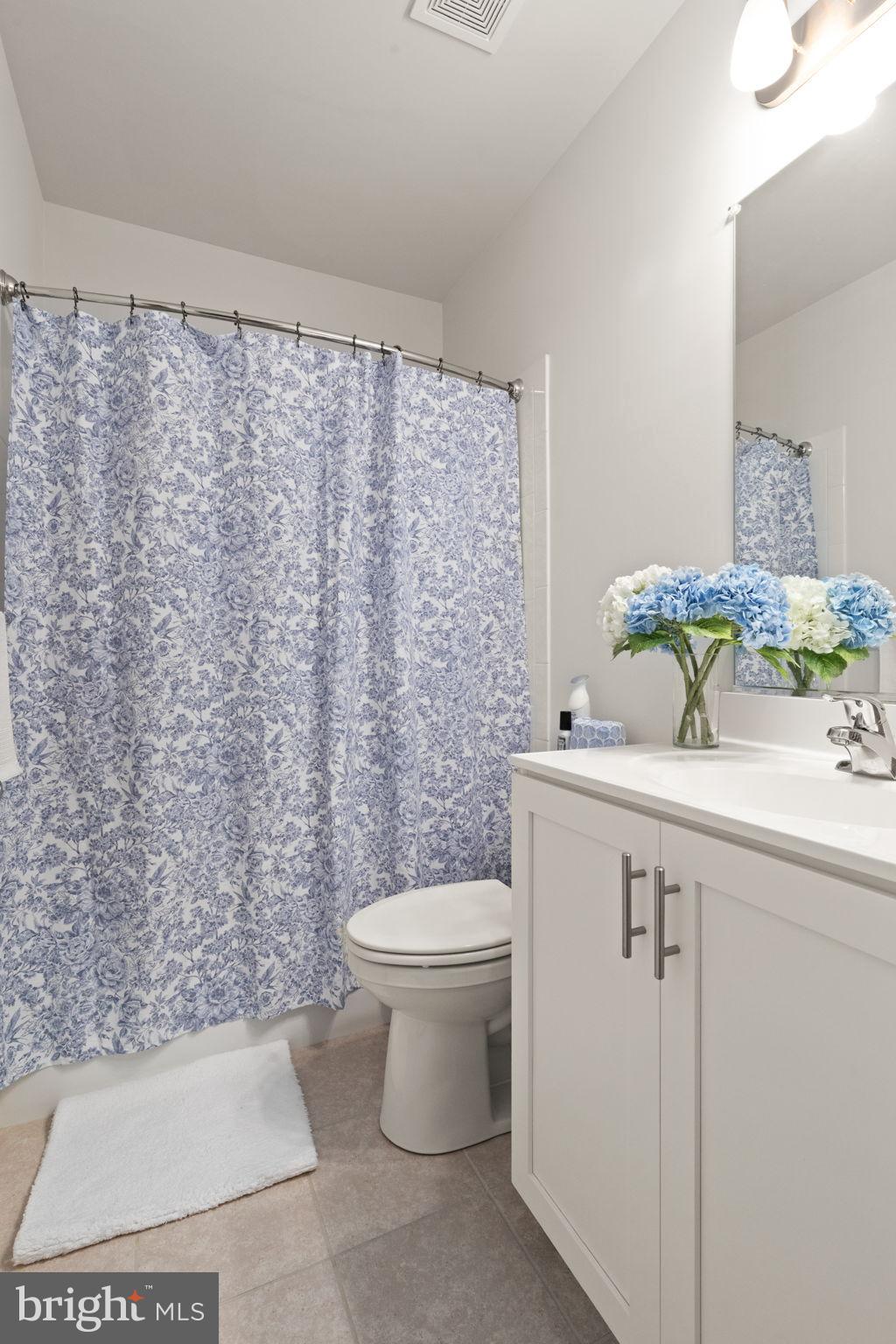 424 Osage Road Cockeysville, MD 21030 - Photo 43 of 52 a bathroom with a sink a toilet and shower curtain