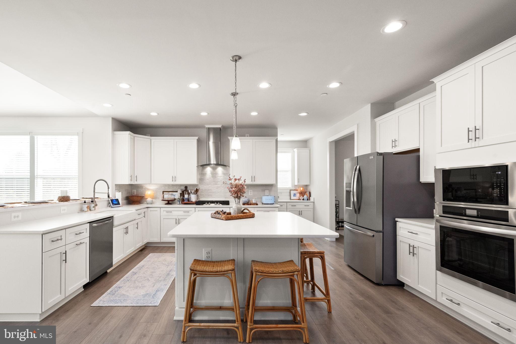 424 Osage Road Cockeysville, MD 21030 - Photo 8 of 52 a kitchen with a sink a kitchen island and stainless steel appliances