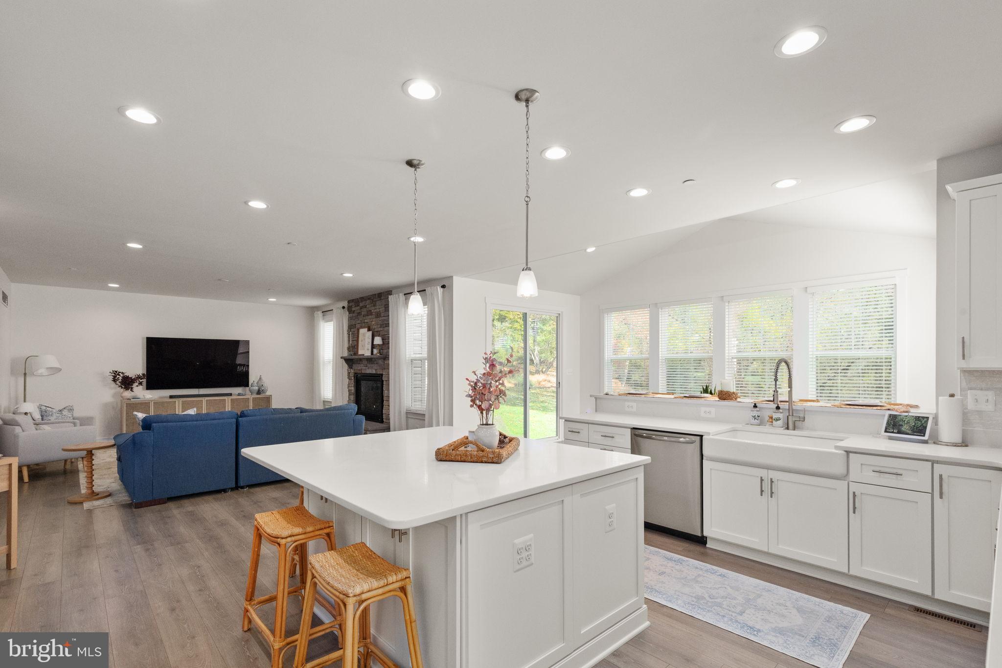 424 Osage Road Cockeysville, MD 21030 - Photo 9 of 52 a large kitchen with kitchen island a sink white cabinets and stainless steel appliances