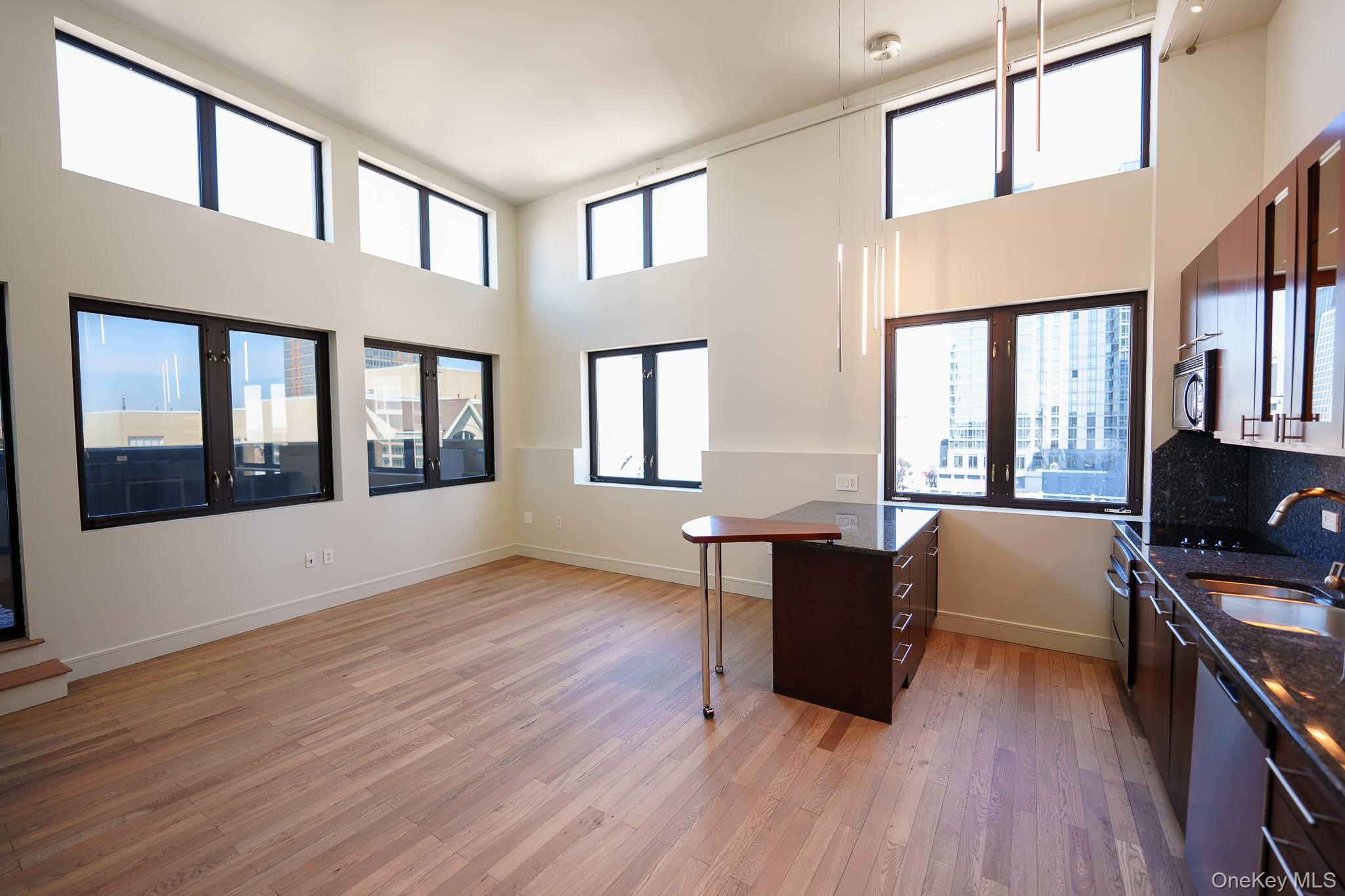 25 Leroy Place, Unit PH1 New Rochelle, NY 10805 - Photo 4 of 14 a view of living room filled with furniture and wooden floor